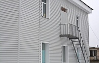 Сайдинг светло-серый на фасаде дома